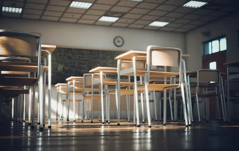 A school classroom filled with empty desks