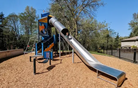 A tall silver slide features in the new playground equipment recently installed at Salt Air Vista Park in Kent, Wash., near Seattle