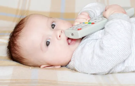 Baby holding a remote control