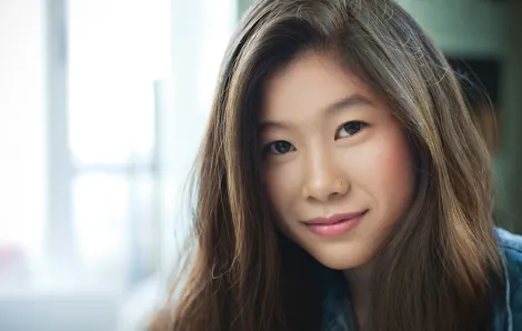 Asian teen girl smiling at camera