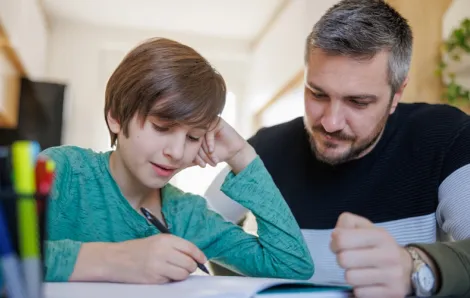 Dad helping neurodivergent child with homework