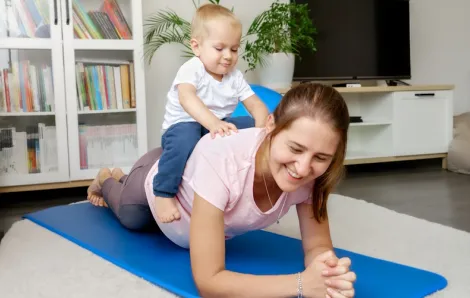 yoga mat with baby on mom's back as they stay active 