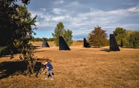 Seattle's biggest parks include Magnuson Park along Lake Washington where a boy plays near the submarine orca fin art installation