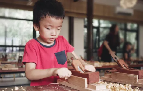 Young boy doing a woodworking project at a seattle art summer camp