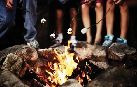 Roasting marshmallows at an classic overnight summer camp
