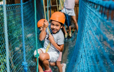 Kid on a high ropes course at a one-of-a-kind summer camp in Seattle