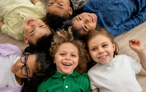 kids on the floor with their heads together