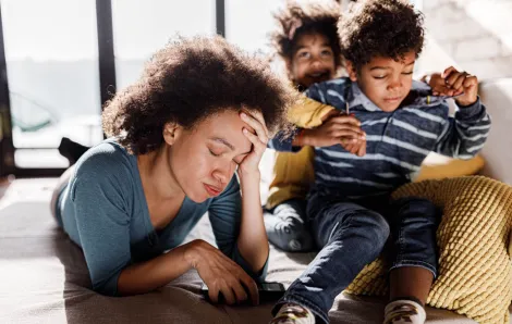 stressed out mom with two kids next to her