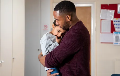 dad holding young son in the hospital
