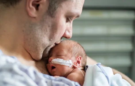 dad with infant in the hospital at a NICU