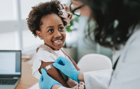 Girl smiling after getting a vaccine shot