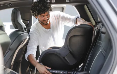 man taking a car seat out of his car