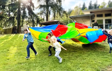 kids playing with a parachute at recess
