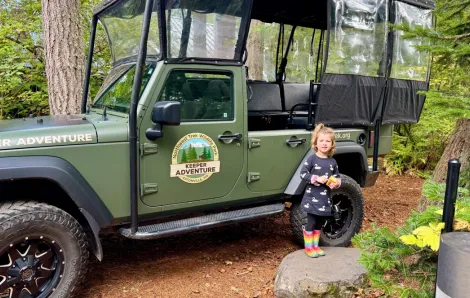 Keeper Adventure jeep with a little girl standing next to it