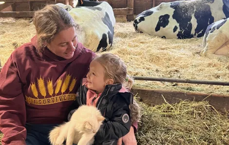 Grandma Lori with Evangeline with the cows in the maternity area
