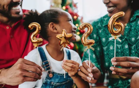 A family holds up balloons showing 2026 for new year's eve in Seattle.