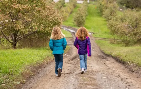 Two girls out for a walk on their own enjoying unsupervised play