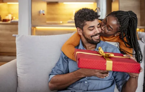 couple giving Valentine's Day gift smiling and happy