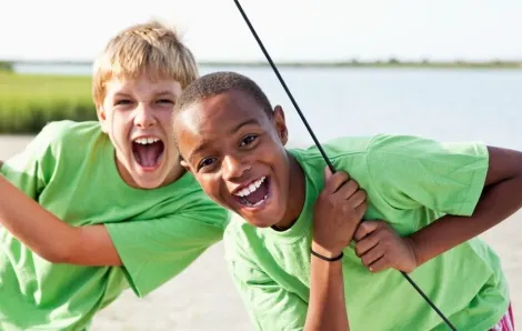 Boys standing on catamaran