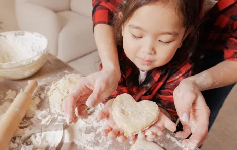 mom and daughter making Valentine's Day treats together in the kitchen
