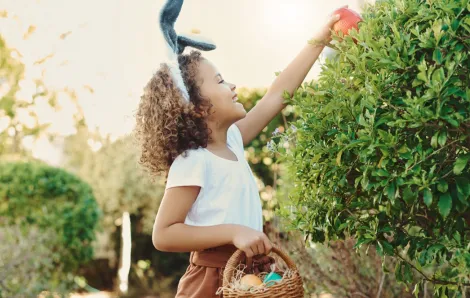 girl finding an Easter egg outside