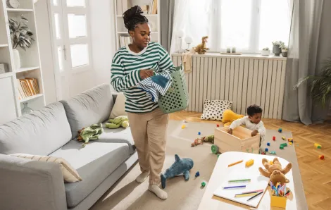 mom and kids picking up toys