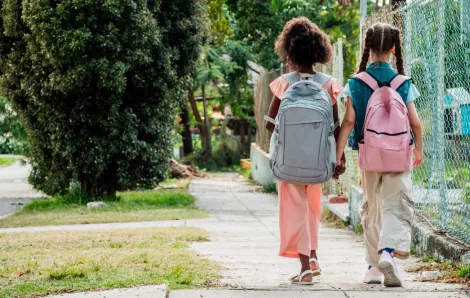 two girls walking to school together