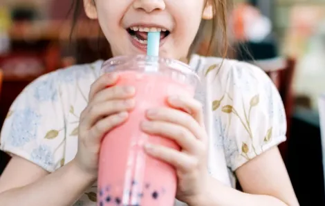 little girl drinking boba bubble tea