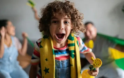 happy kid and family watching fifa