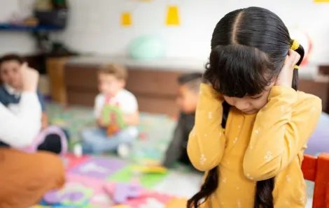 preschool girl frustrated covering her ears