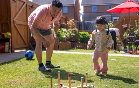 grandpa and girl playing yard games on Father's Day