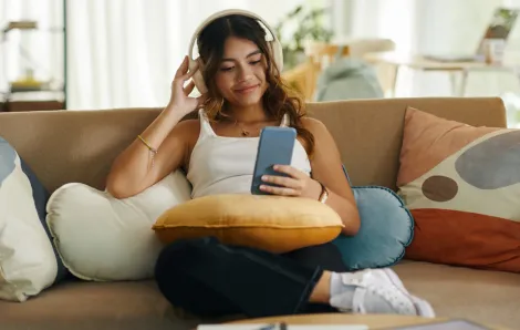 girl listening to music on her couch