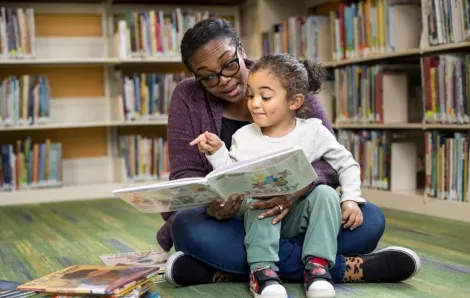 parent and child reading at library