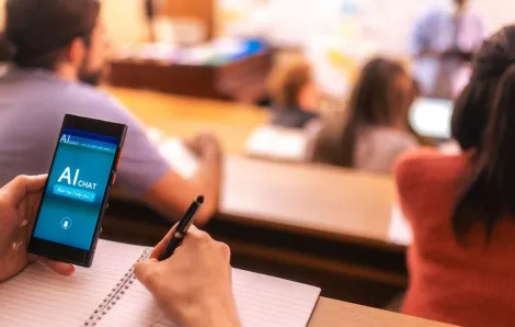 Student using AI app on mobile phone in classroom
