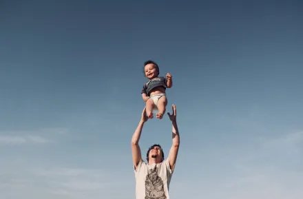 Father tossing his son into the air