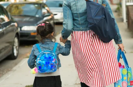 Mom with young kid on way to school