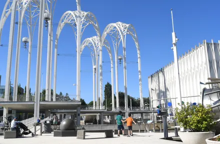 Boys play under the iconic arches of Seattle’s Pacific Science Center, back open after more than two years
