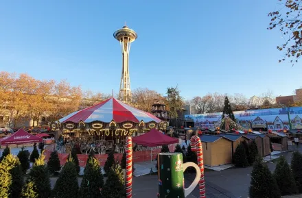 Seattle Christmas Market is it good for kids carousel with Space Needle and vendor village behind