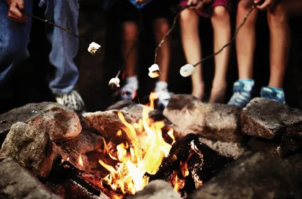 Roasting marshmallows at an classic overnight summer camp