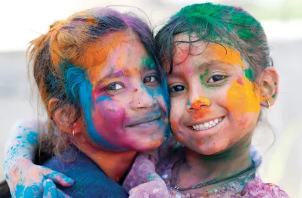 Two girls covered in colors at a Holi celebration