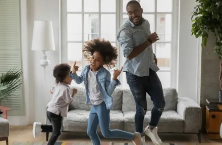 Family being active indoors dancing 
