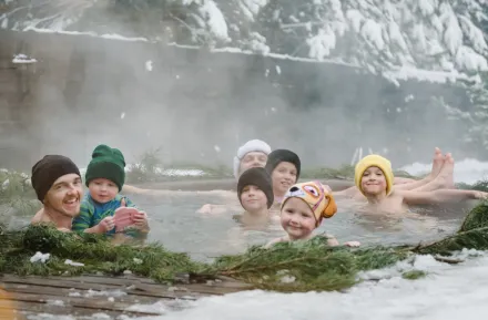 Adults and kids in a natural hot spring