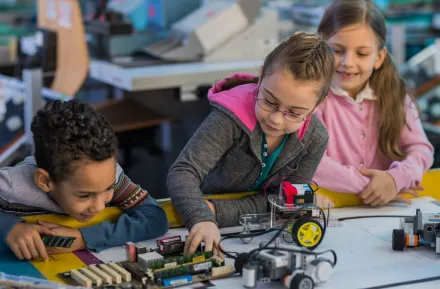 kids working on a robotics project at a mid-winter camp