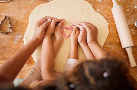 parent and child making valentine's day treats together