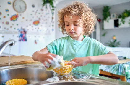 child washing dishes