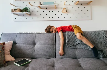 unmotivated child on the back of a couch