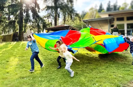kids playing with a parachute at recess