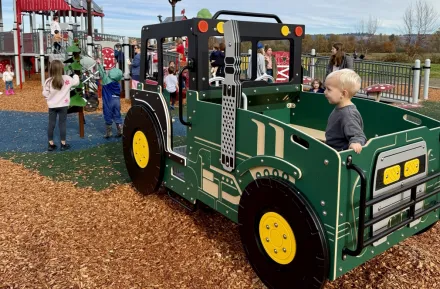 A child at a farm themed playground near Seattle on a sunny weekend