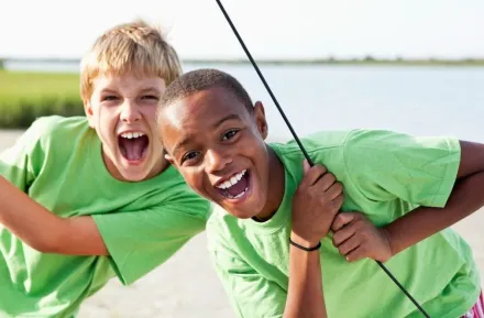 Boys standing on catamaran
