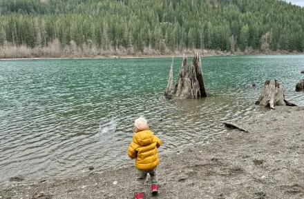 boy playing at the edge of the cedar river